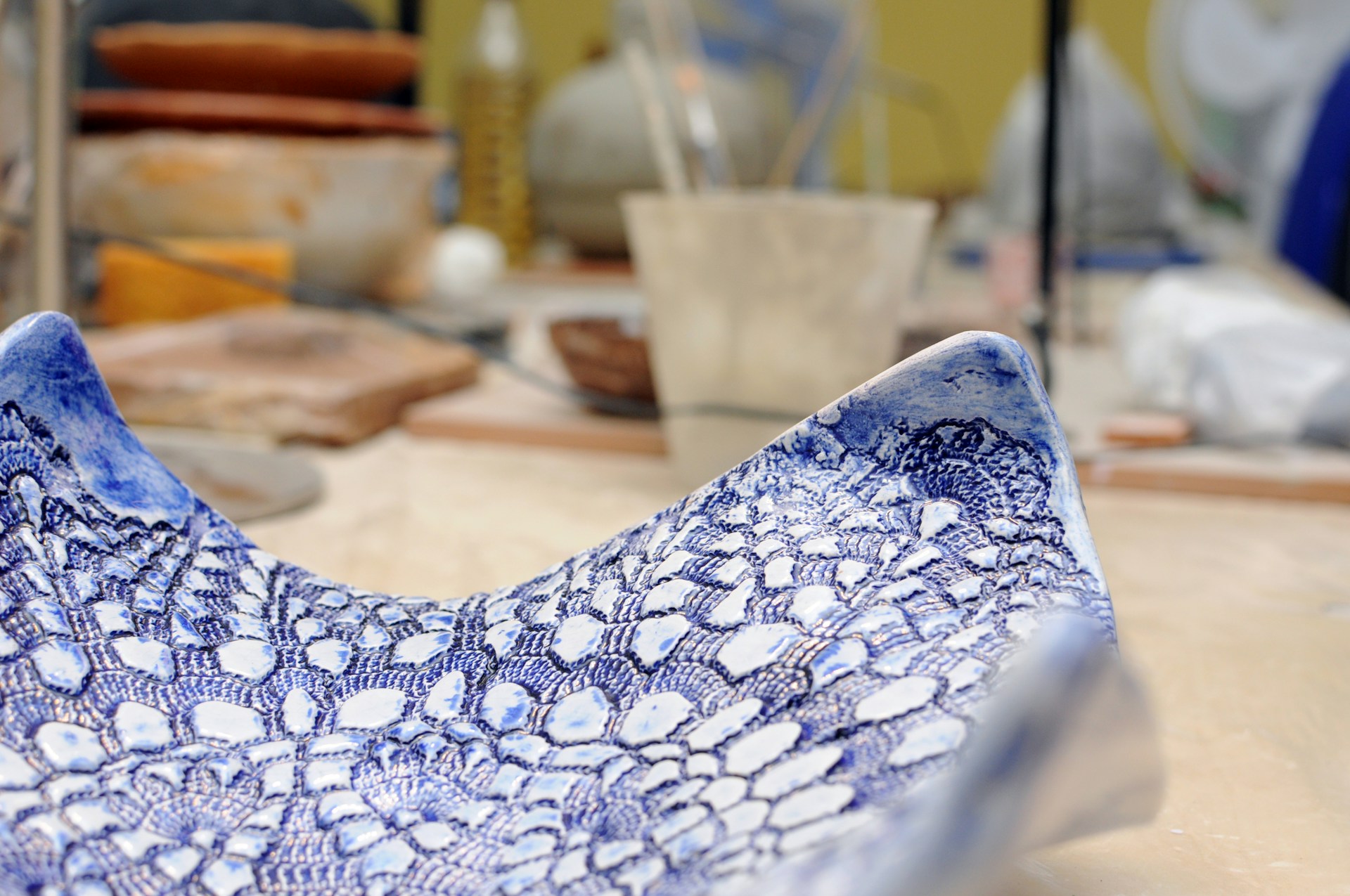 A close-up of intricately designed ceramic pieces with unique glazes.