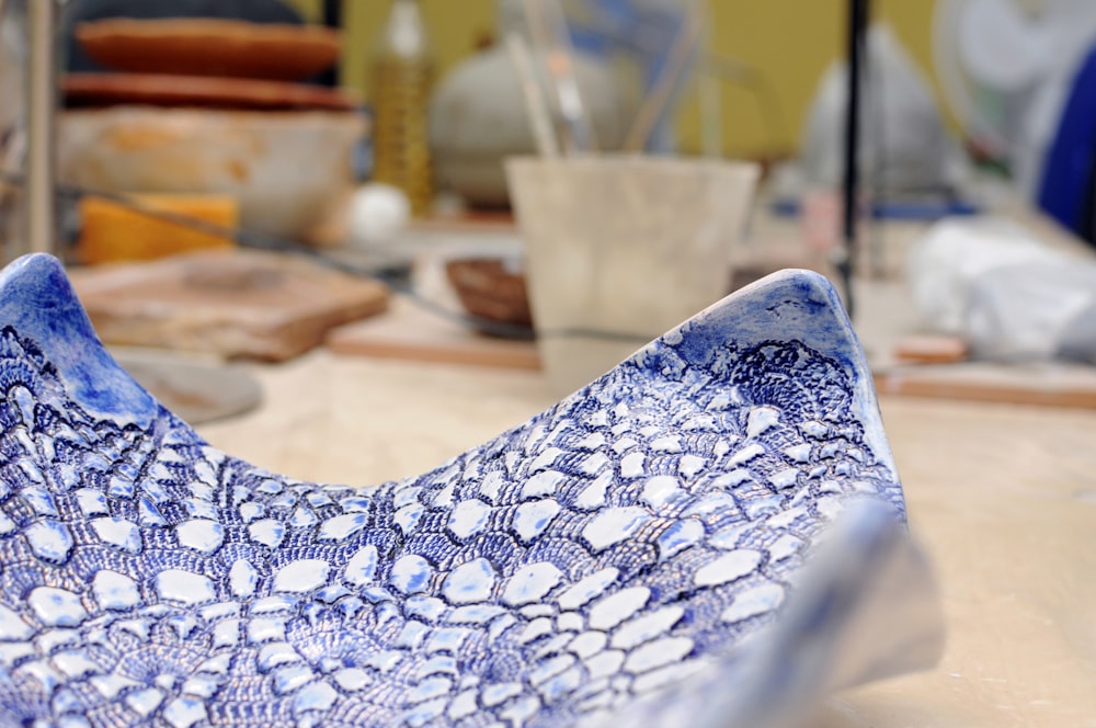 a blue and white bowl sitting on top of a table