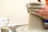 Close-up of hands shaping clay on a pottery wheel in a bright studio.
