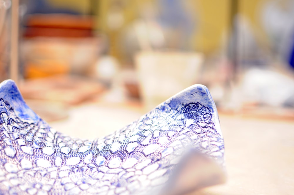 a blue and white vase sitting on top of a table