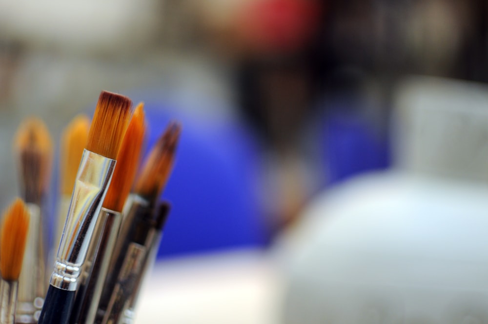 a close up of a group of paint brushes