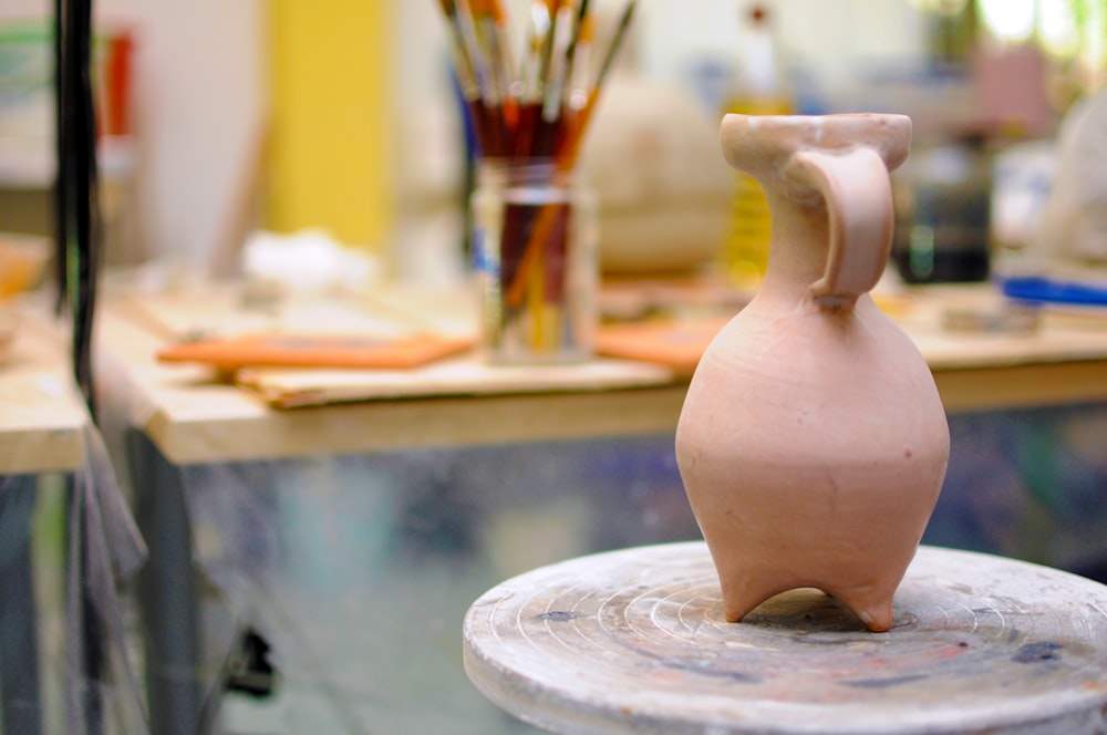 a vase sitting on top of a table in a room