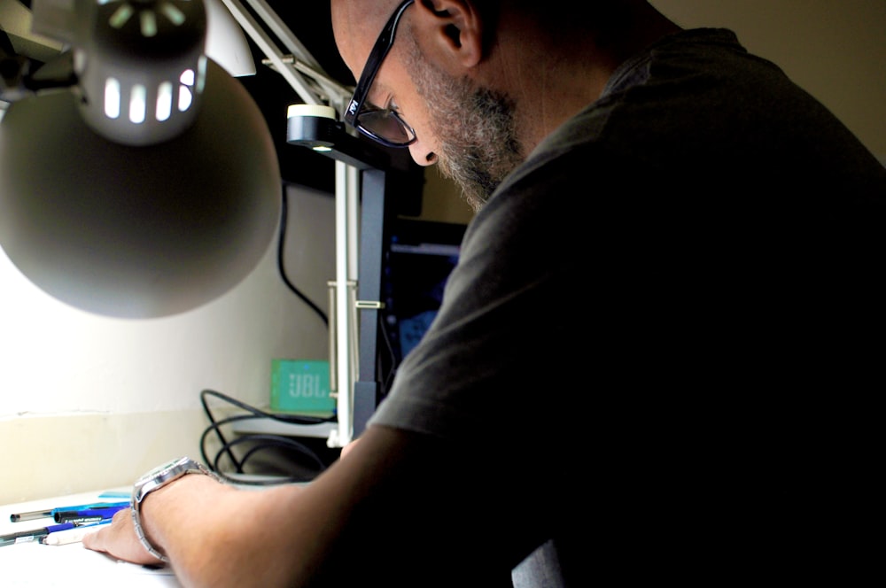 a man sitting at a desk working on a computer