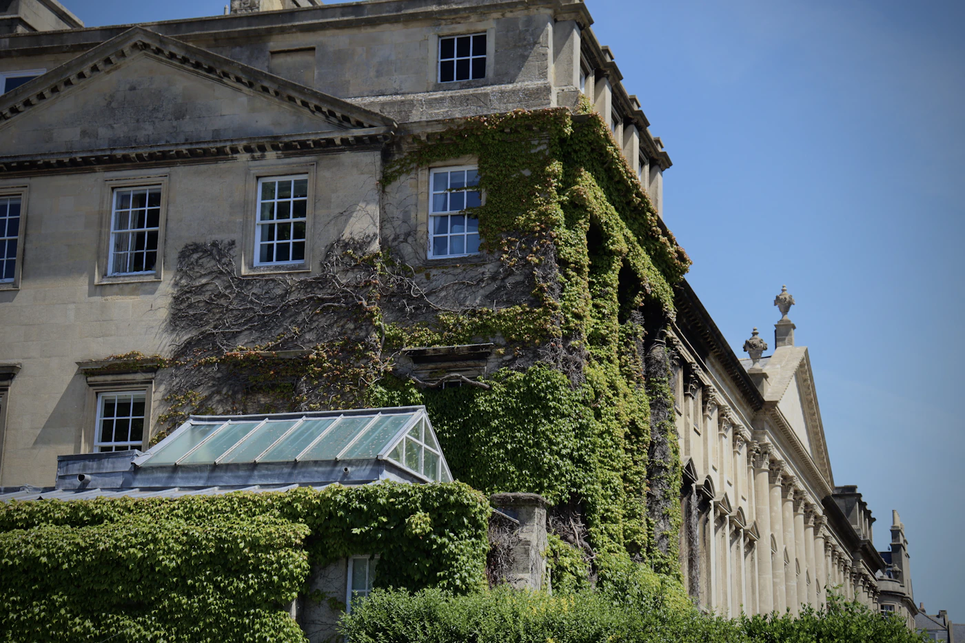 An old stone building with ivy growing up its side