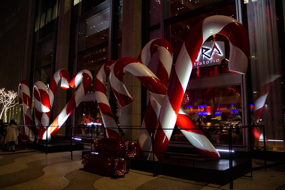 a large candy cane sculpture in front of a building