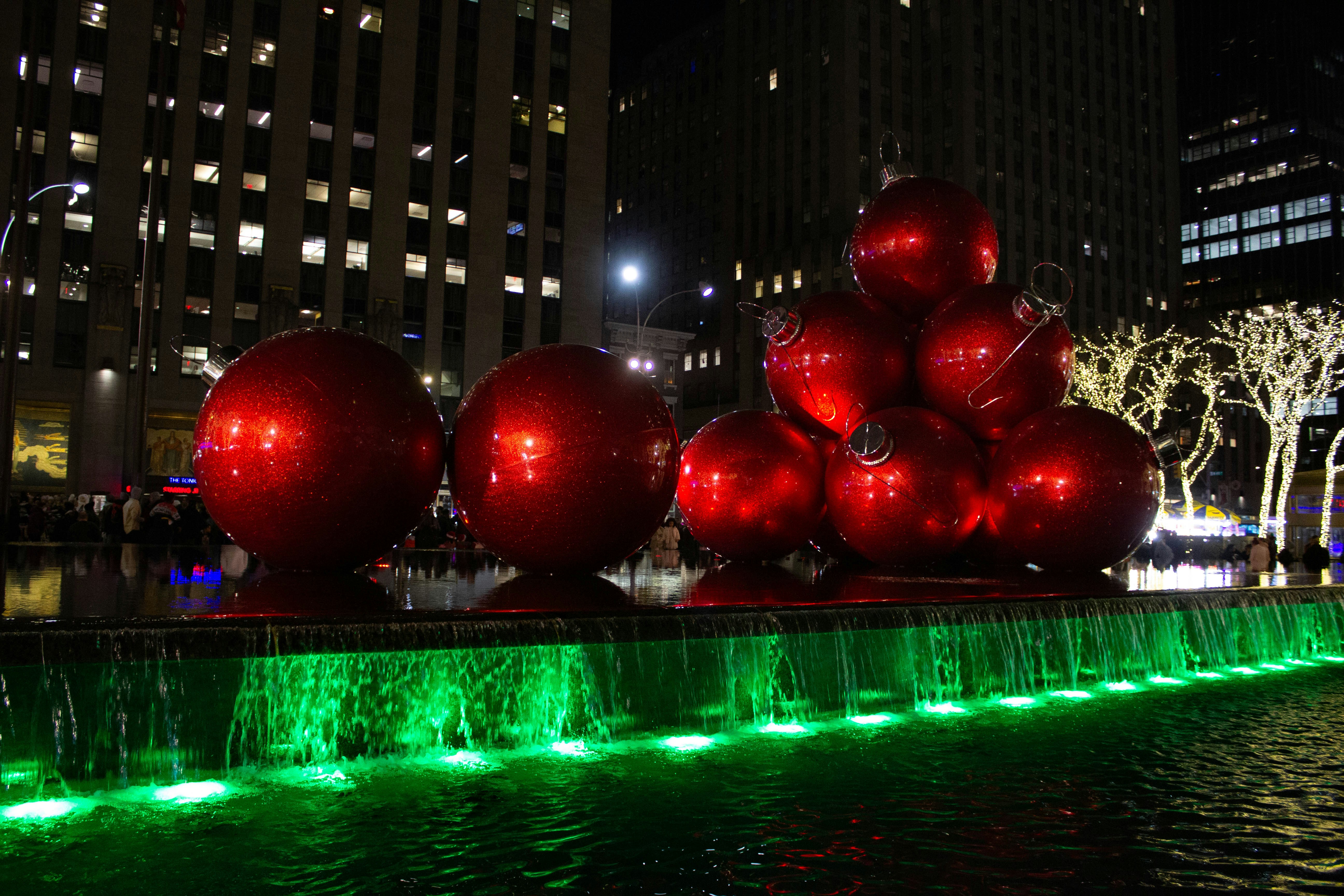 a fountain with christmas ornaments in the middle of it