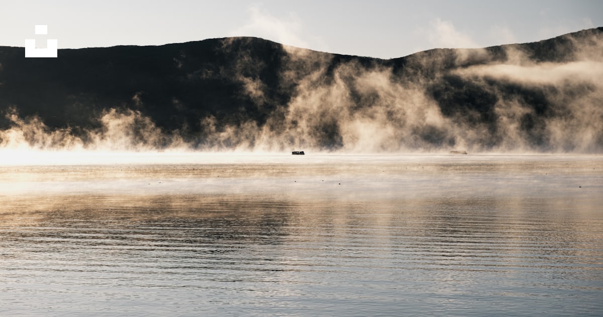A body of water with steam rising from it photo – Free Nature Image on ...