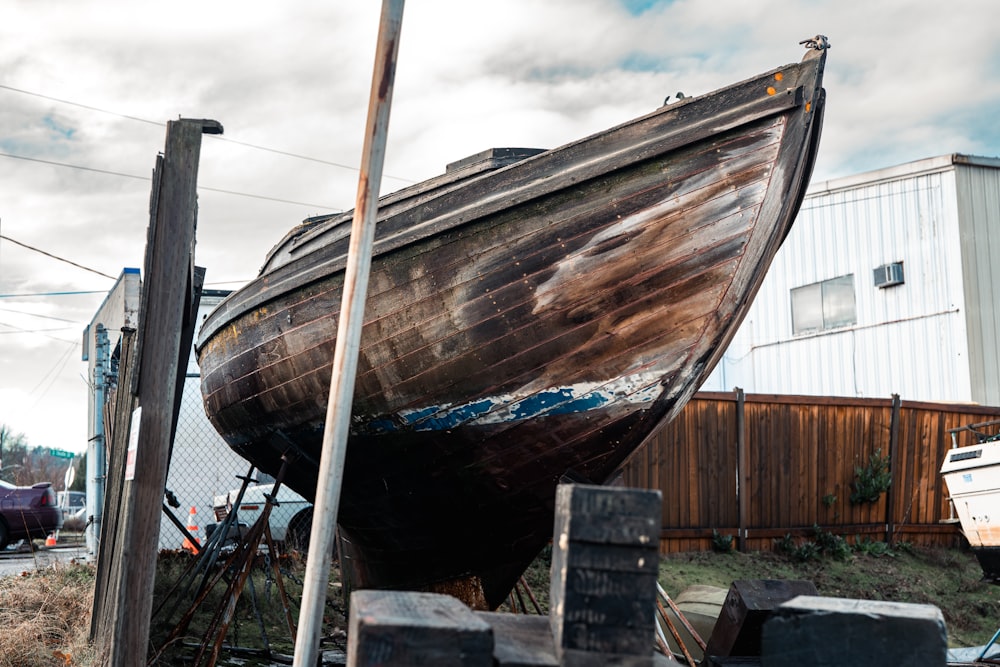 a boat sitting on top of a pile of wood