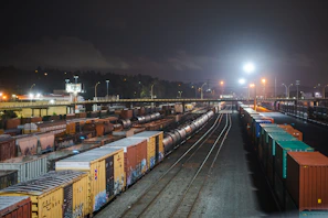 Evening scene of haulora trucks parked at a busy freight yard