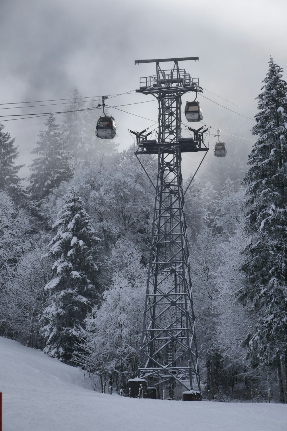 a ski lift going up a snowy mountain