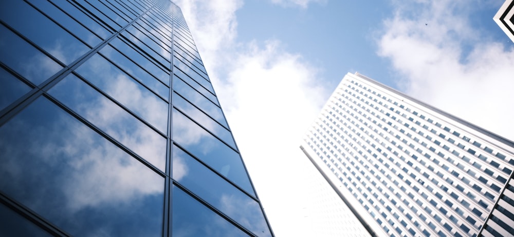 two tall buildings with a sky background