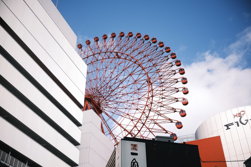 a large ferris wheel sitting next to a tall building