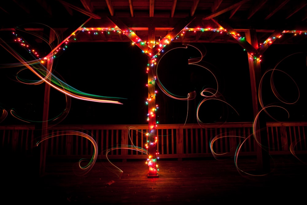 a lit up tree in the dark with lights on it