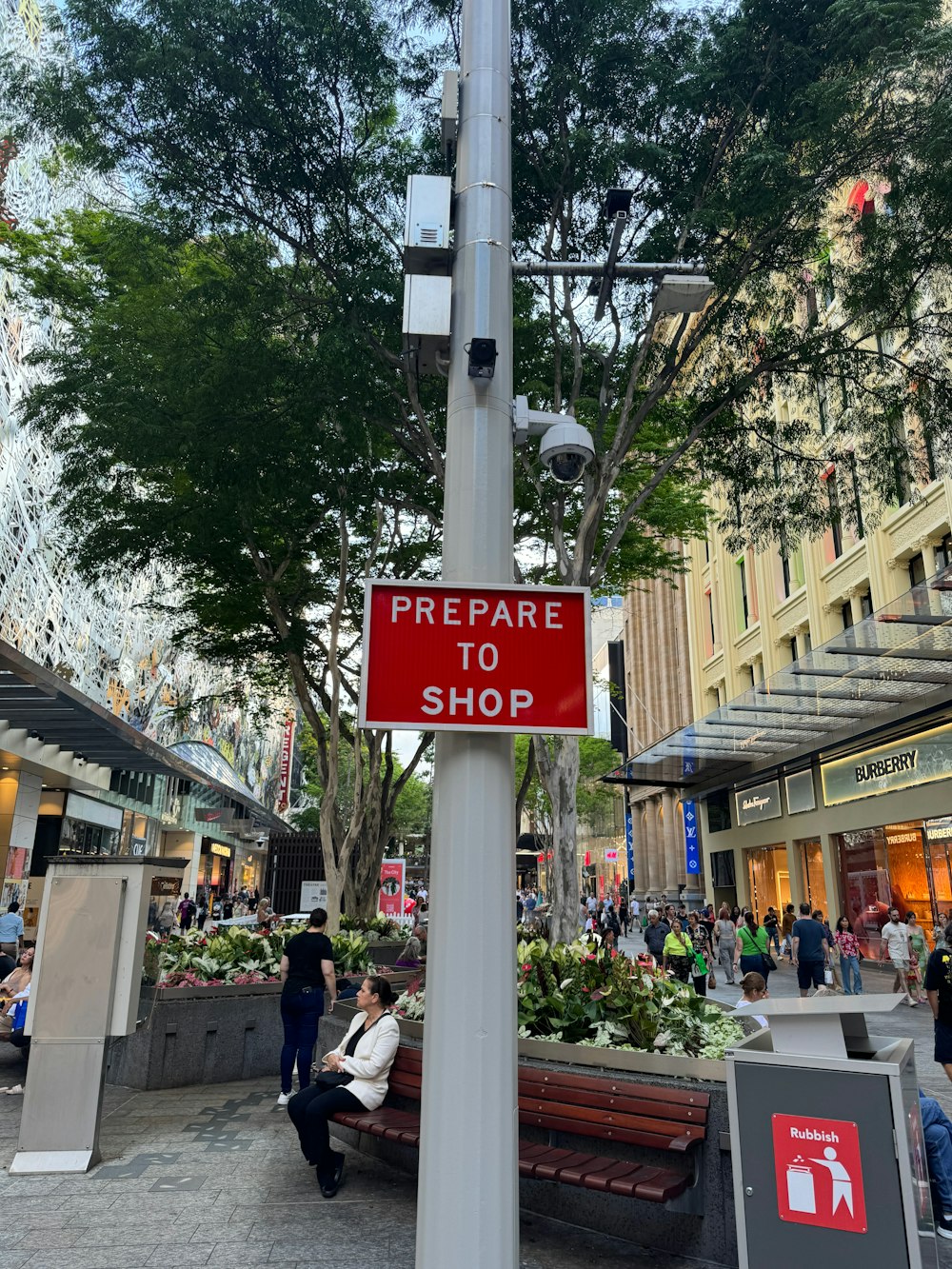 a red sign that says prepare to shop on a pole