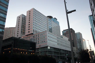 A modern office skyline blending Saudi and American architectural styles at dusk.