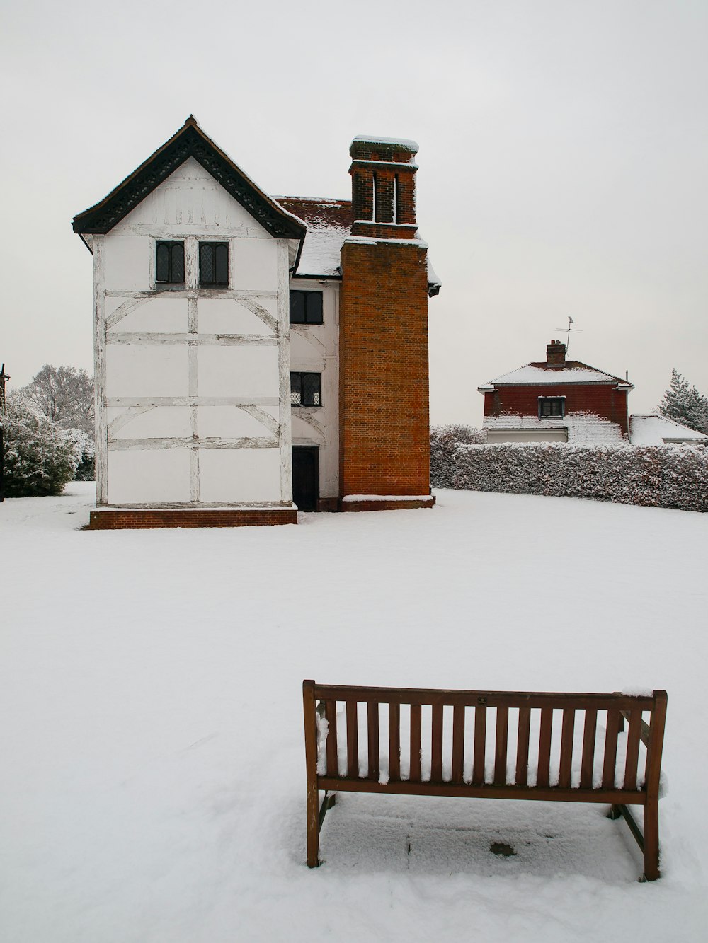 a bench sitting in the snow next to a building