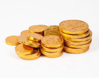 a pile of gold coins sitting on top of each other