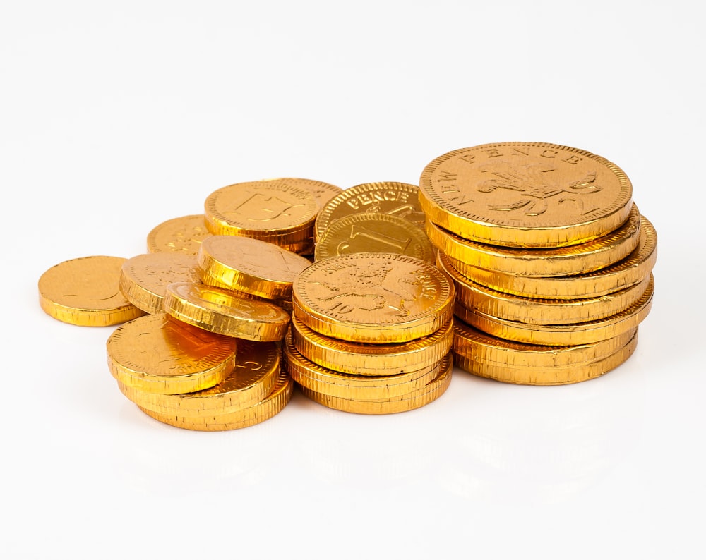 a pile of gold coins sitting on top of each other