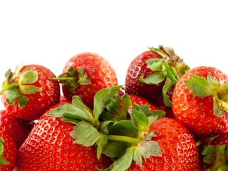 A close-up of ripe strawberries growing in a vibrant garden.