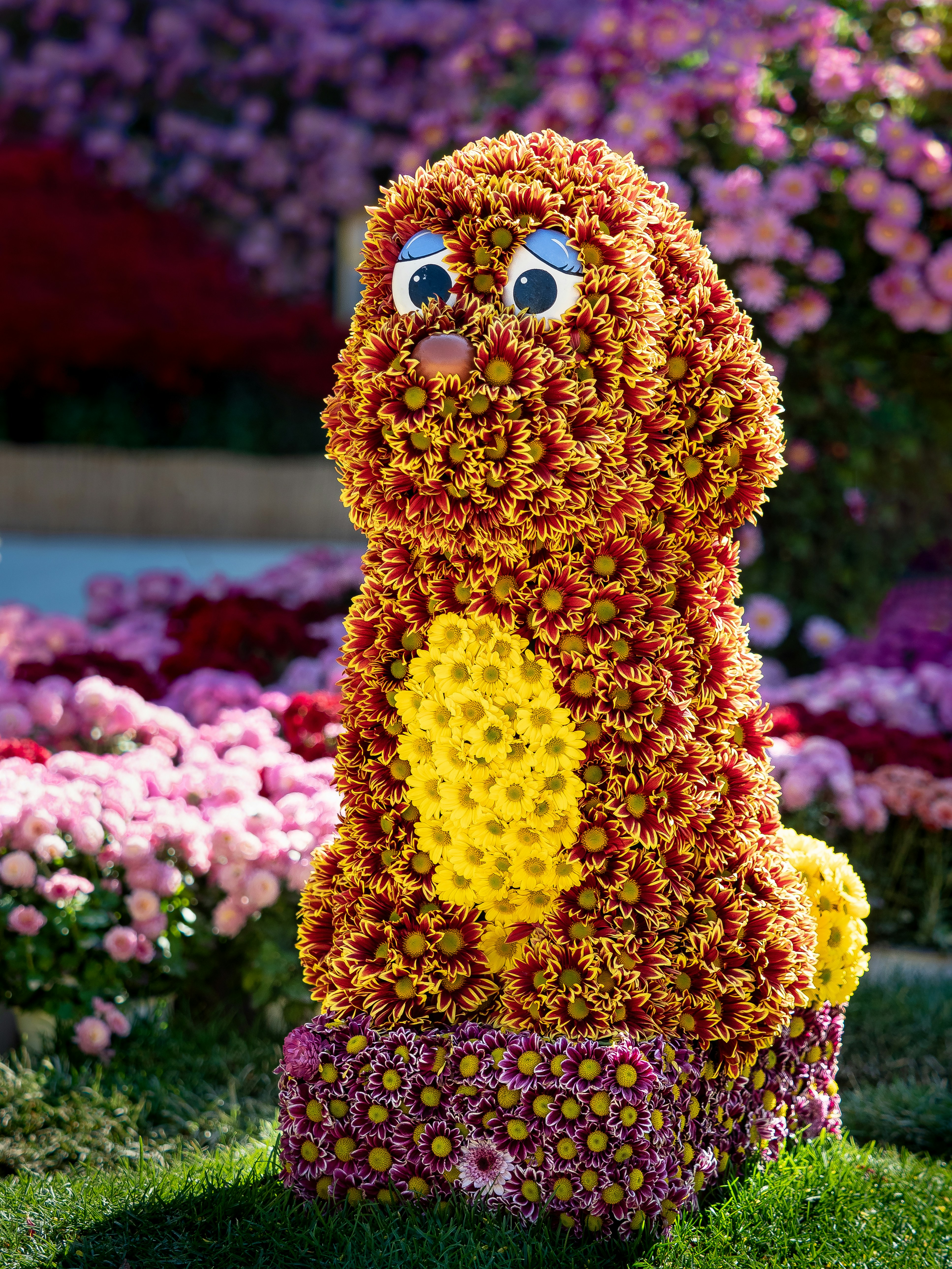 a sculpture of a dog made out of flowers