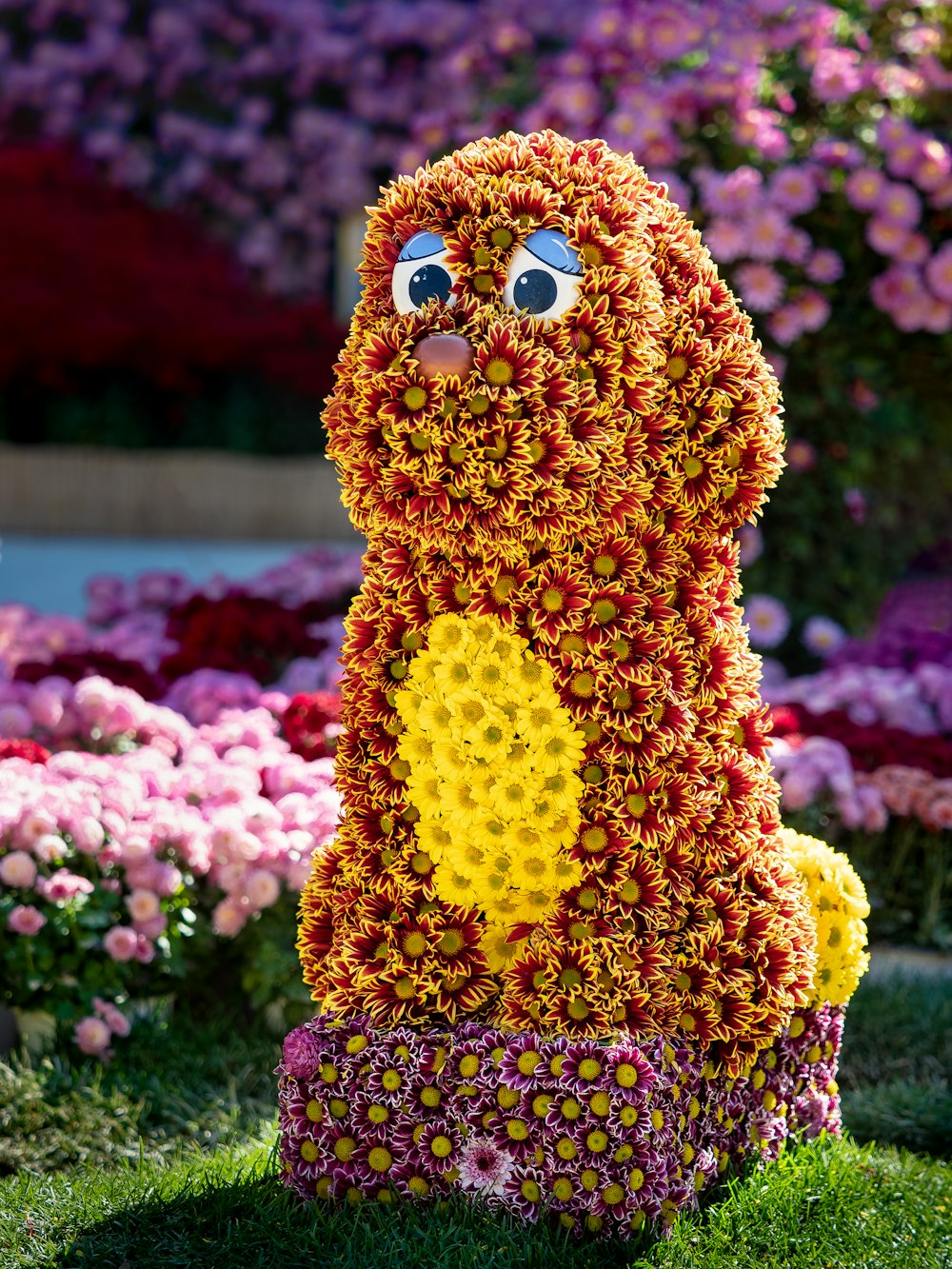 a sculpture of a dog made out of flowers