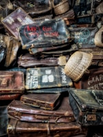 Stylish leather travel bag placed near a vintage suitcase