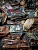 A set of leather luggage tags hanging from a vintage suitcase, showcasing smooth textures and embossed initials.