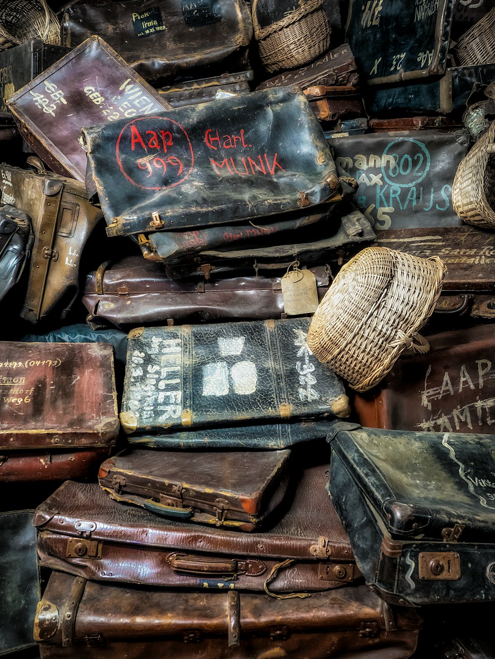 a pile of old suitcases sitting next to each other