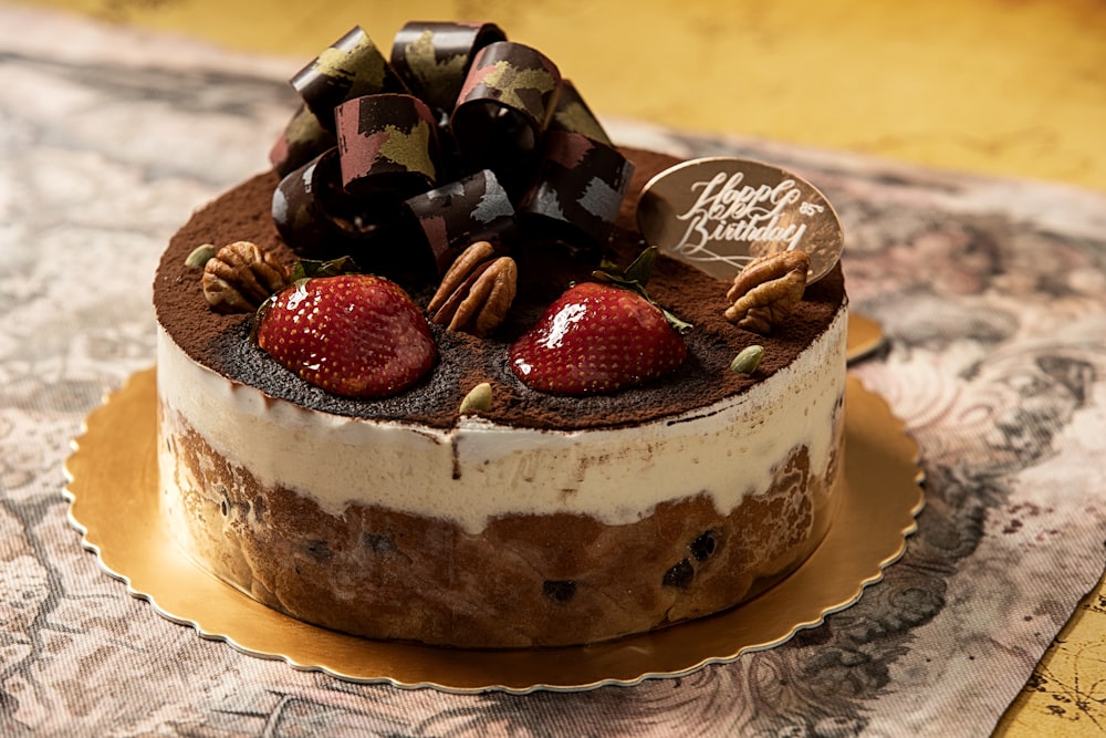 a chocolate cake with strawberries and nuts on top