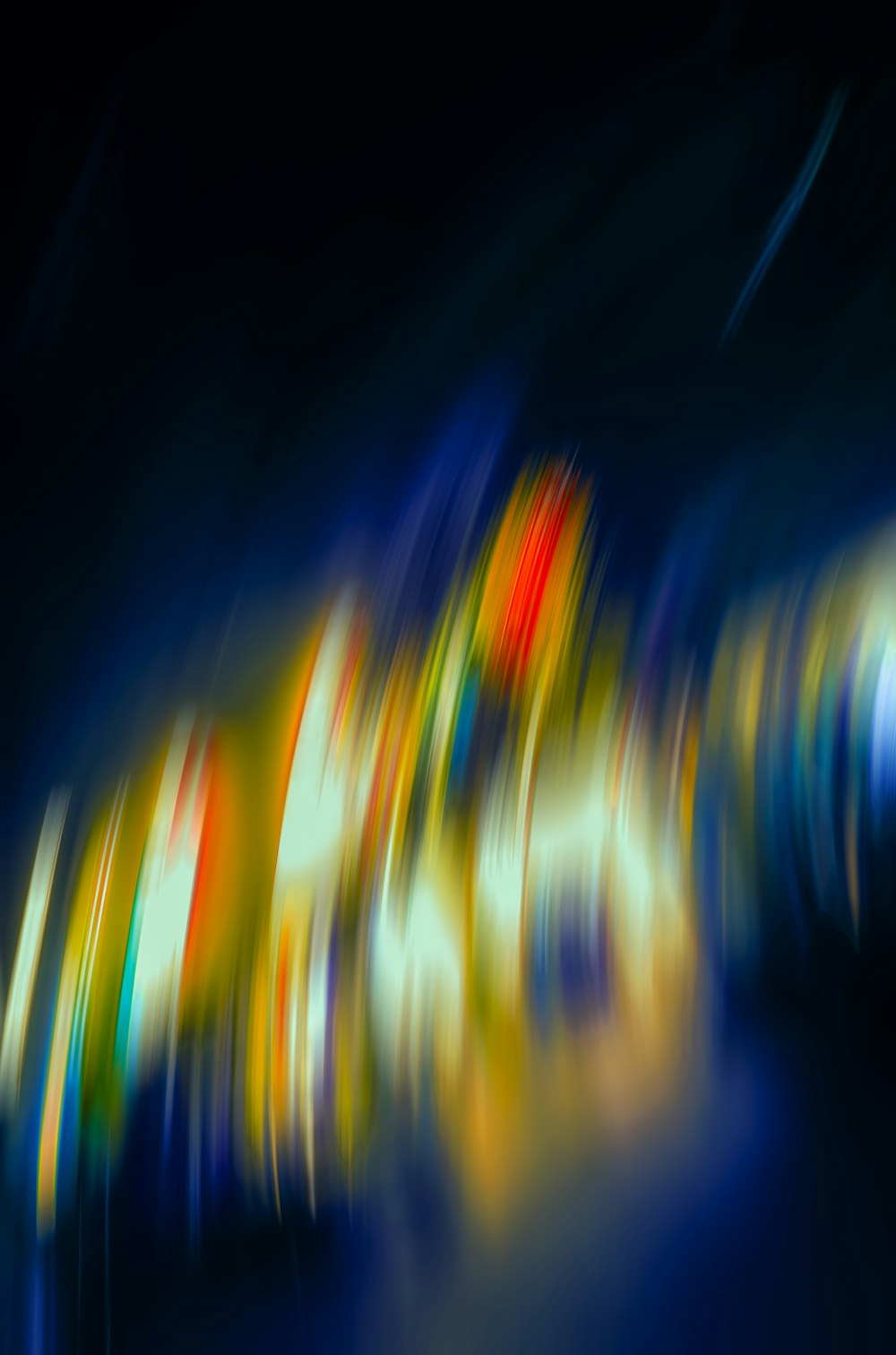 a blurry photo of a colorful object in the dark