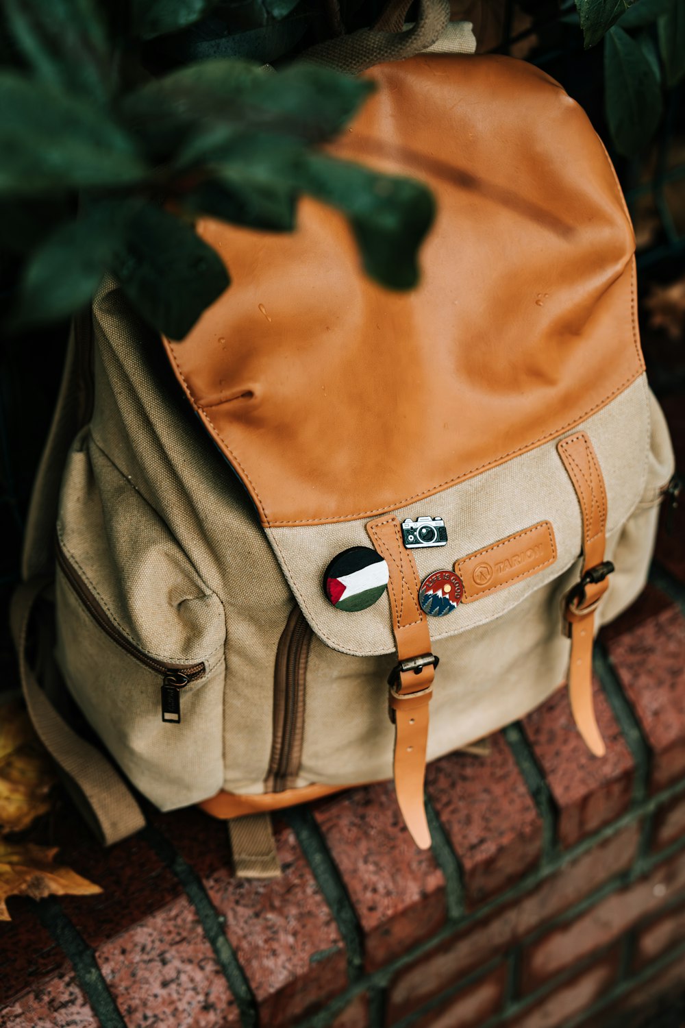 a backpack sitting on top of a brick wall