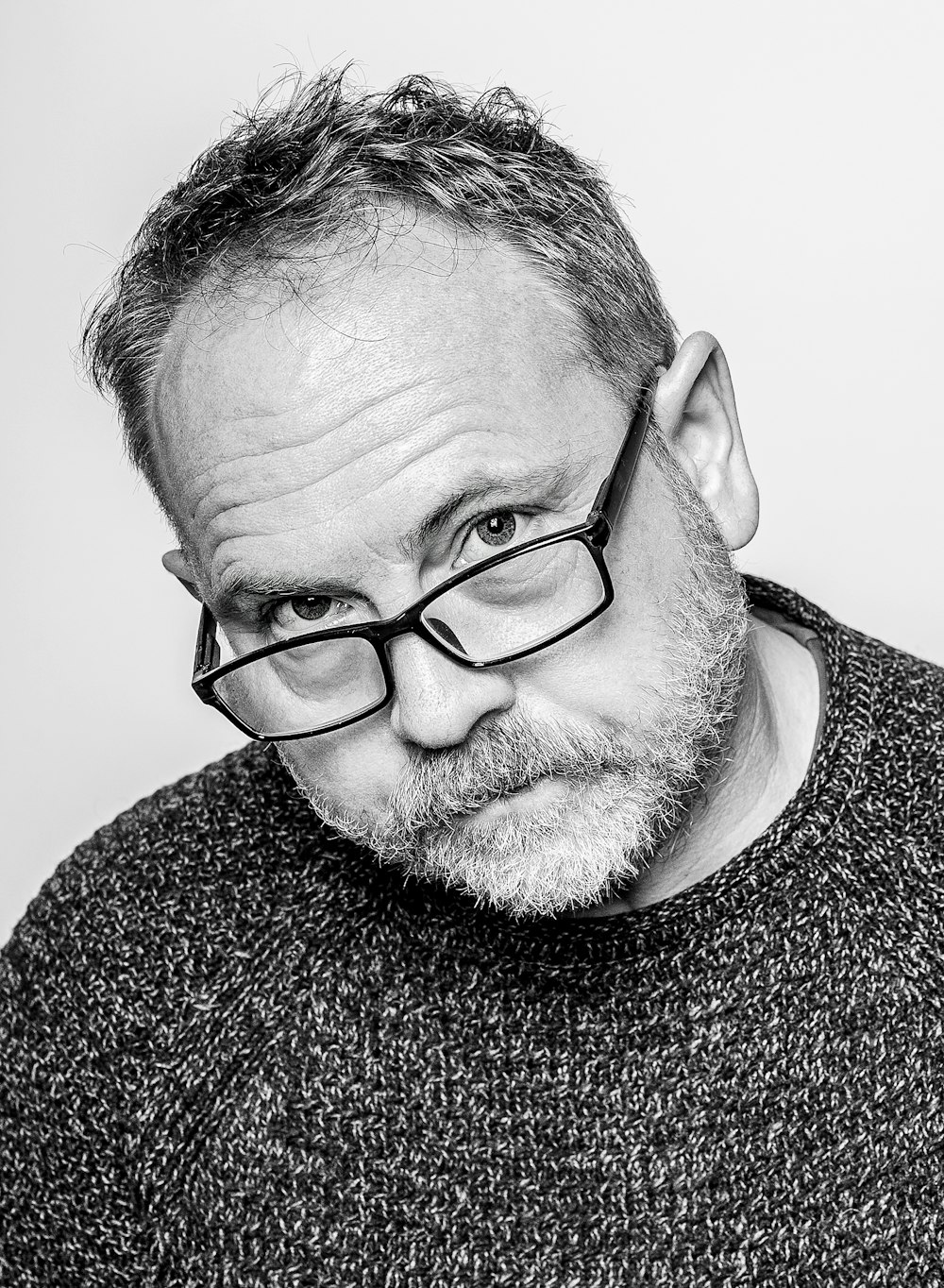 a black and white photo of a man with glasses