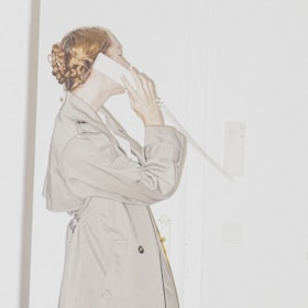 Friendly coordinator speaking on the phone, offering support to a caregiver.