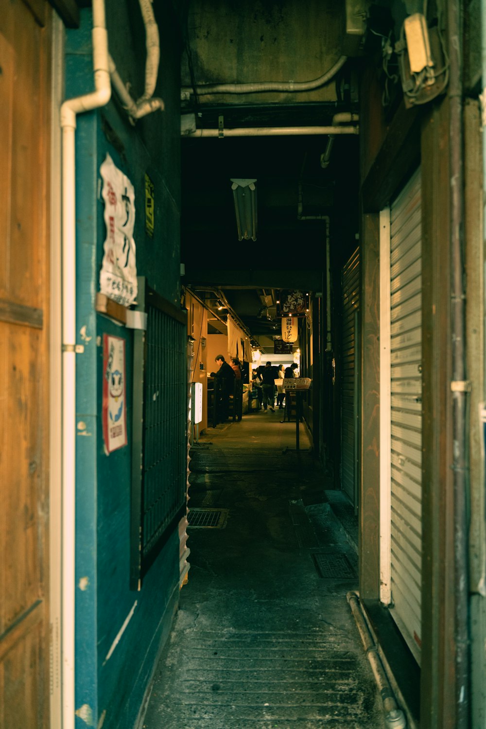 a narrow alley way with an open door