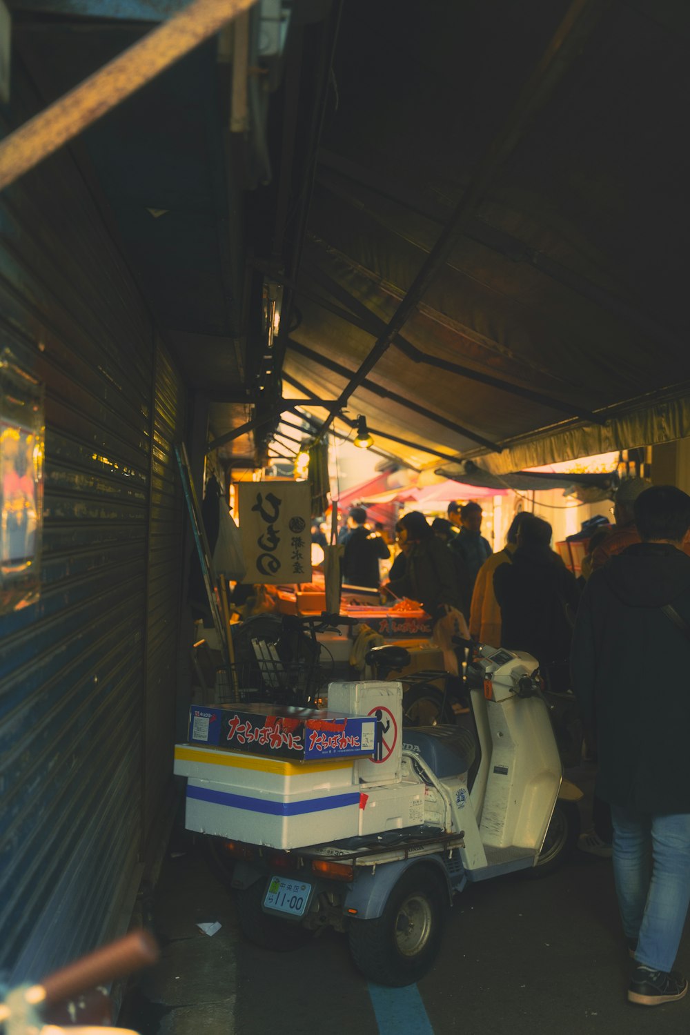 a group of people standing around a food cart