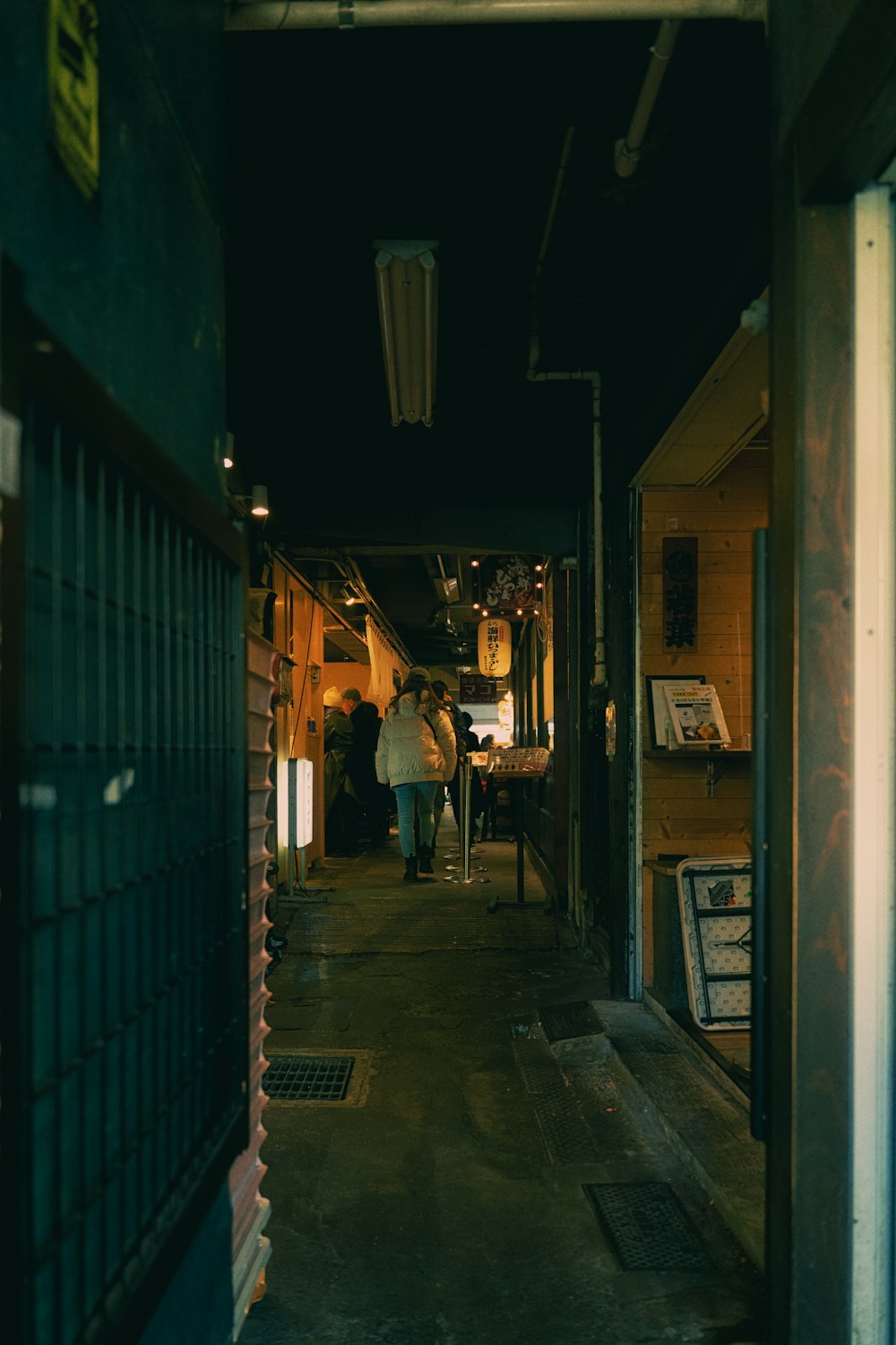 a man is walking down a dark alley way