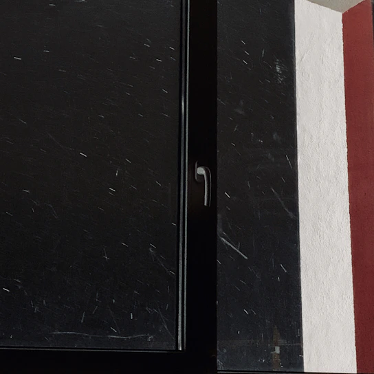 Close-up of a freshly painted window frame showing smooth, even brush strokes.