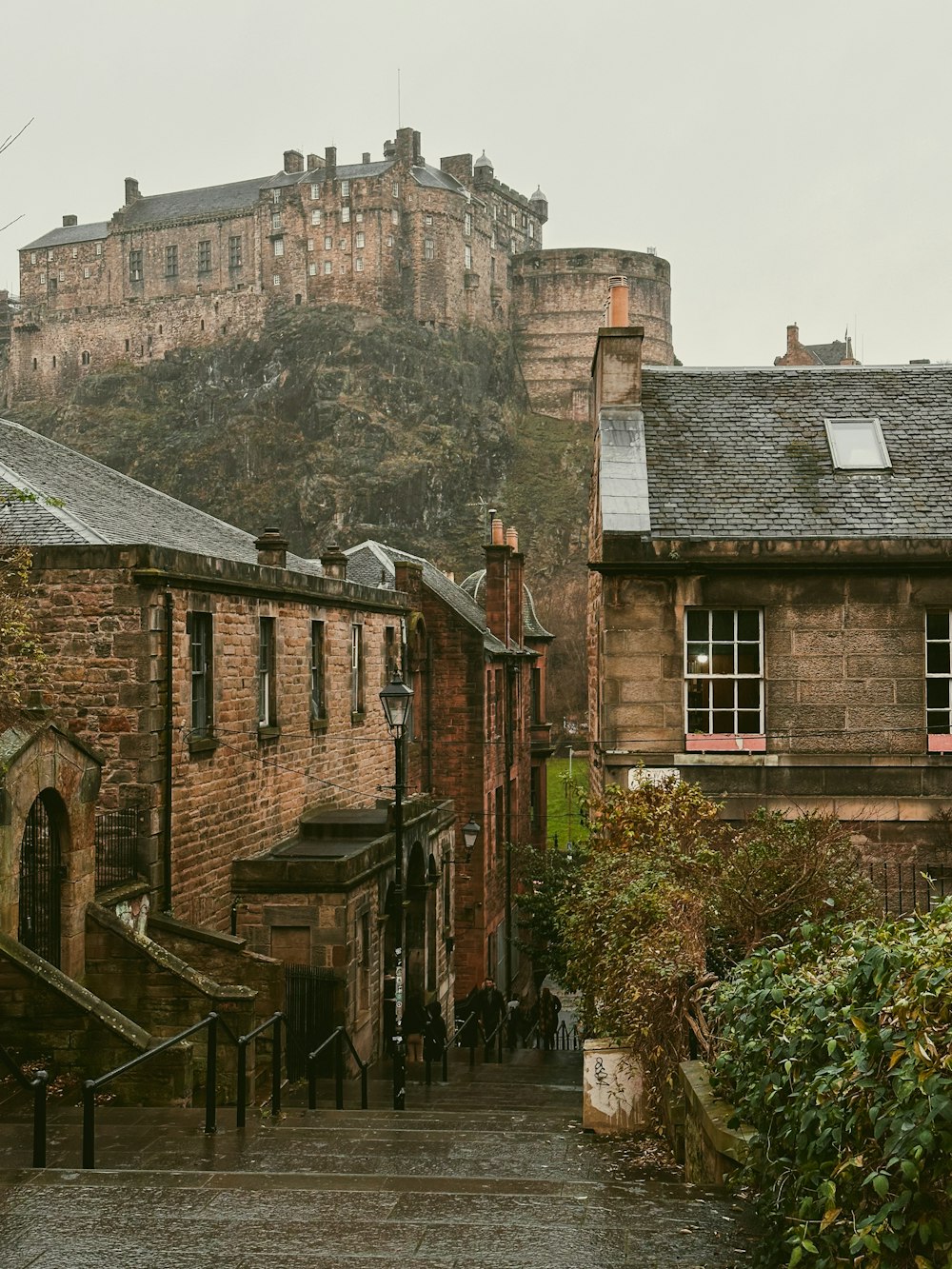 a stone building with a castle in the background