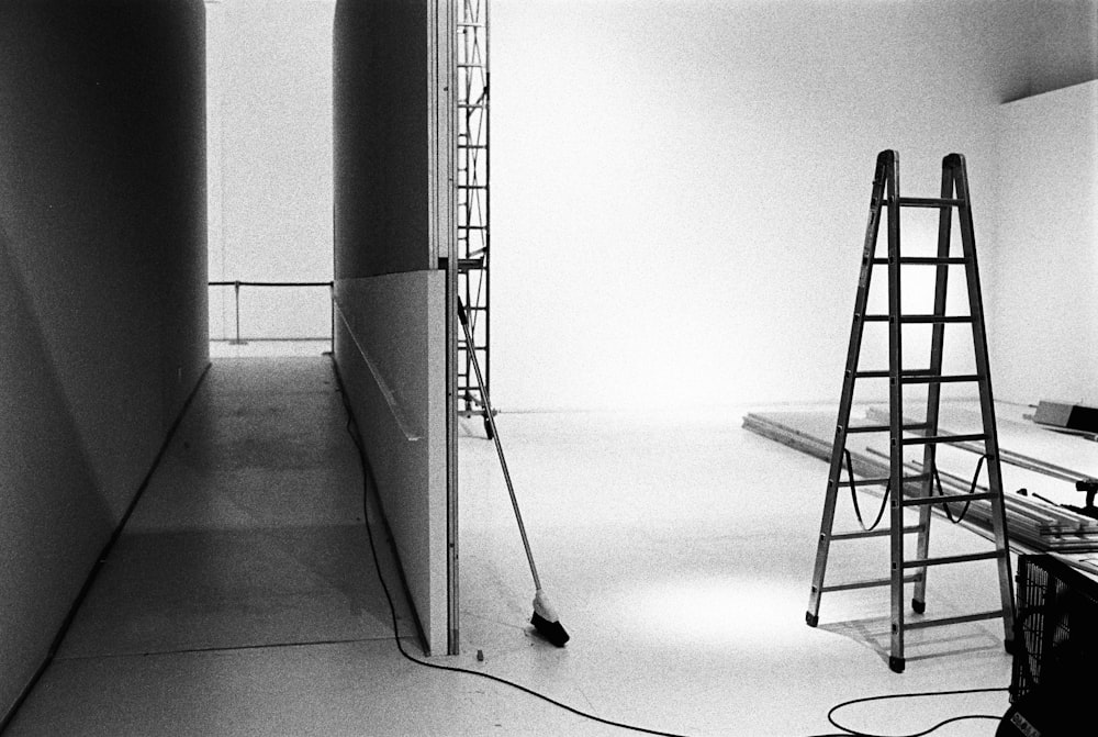 a black and white photo of a room with a ladder