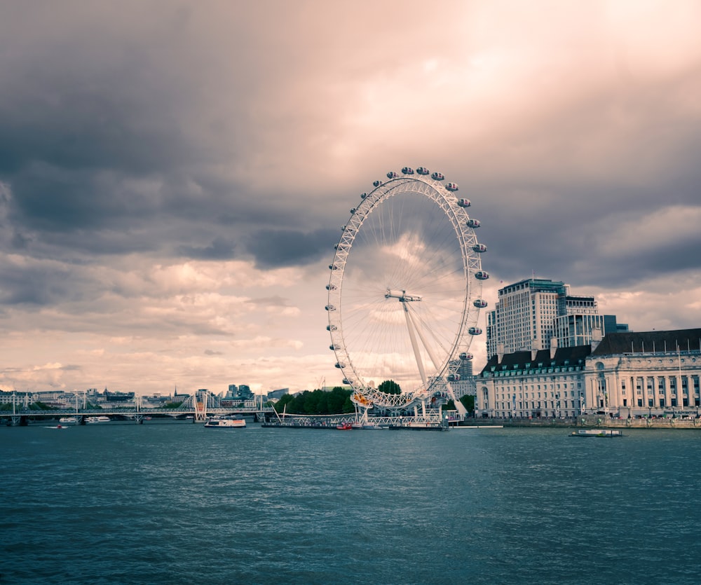 a large ferris wheel sitting in the middle of a body of water