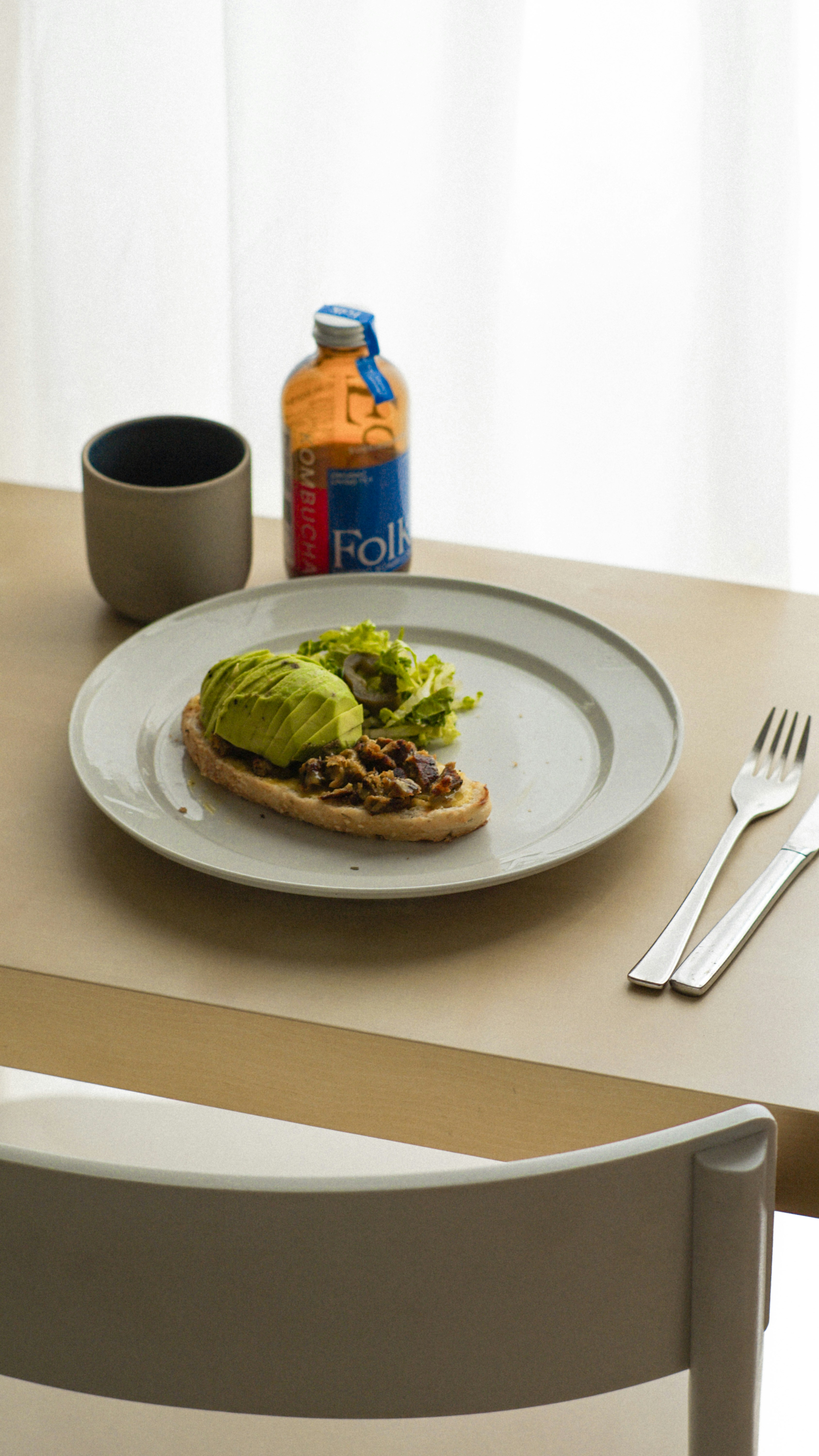 a white plate topped with an avocado on top of a table