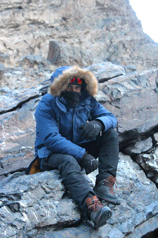 A person wearing a Heatguard heated vest outdoors on a crisp morning with a scenic Australian backdrop.