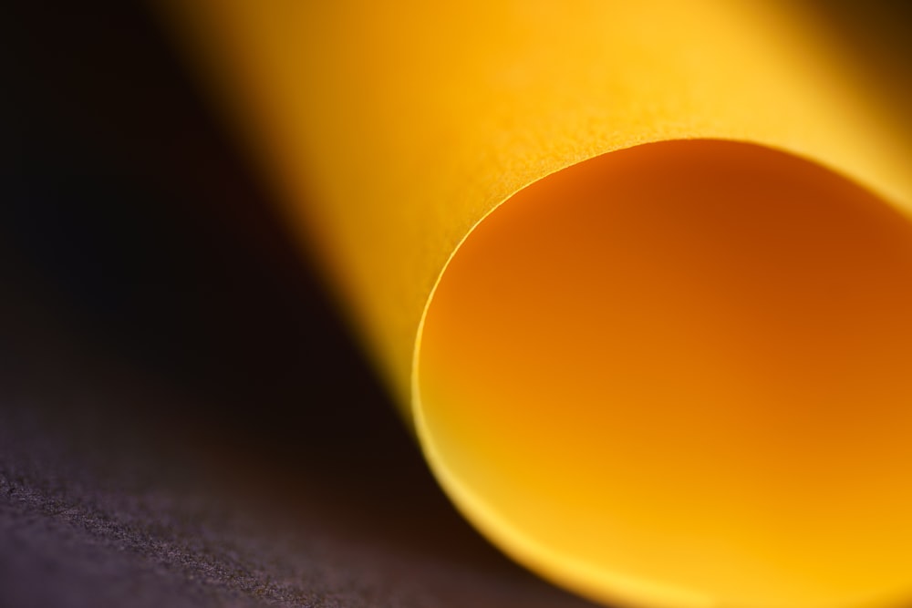 a close up of a yellow tube on a table