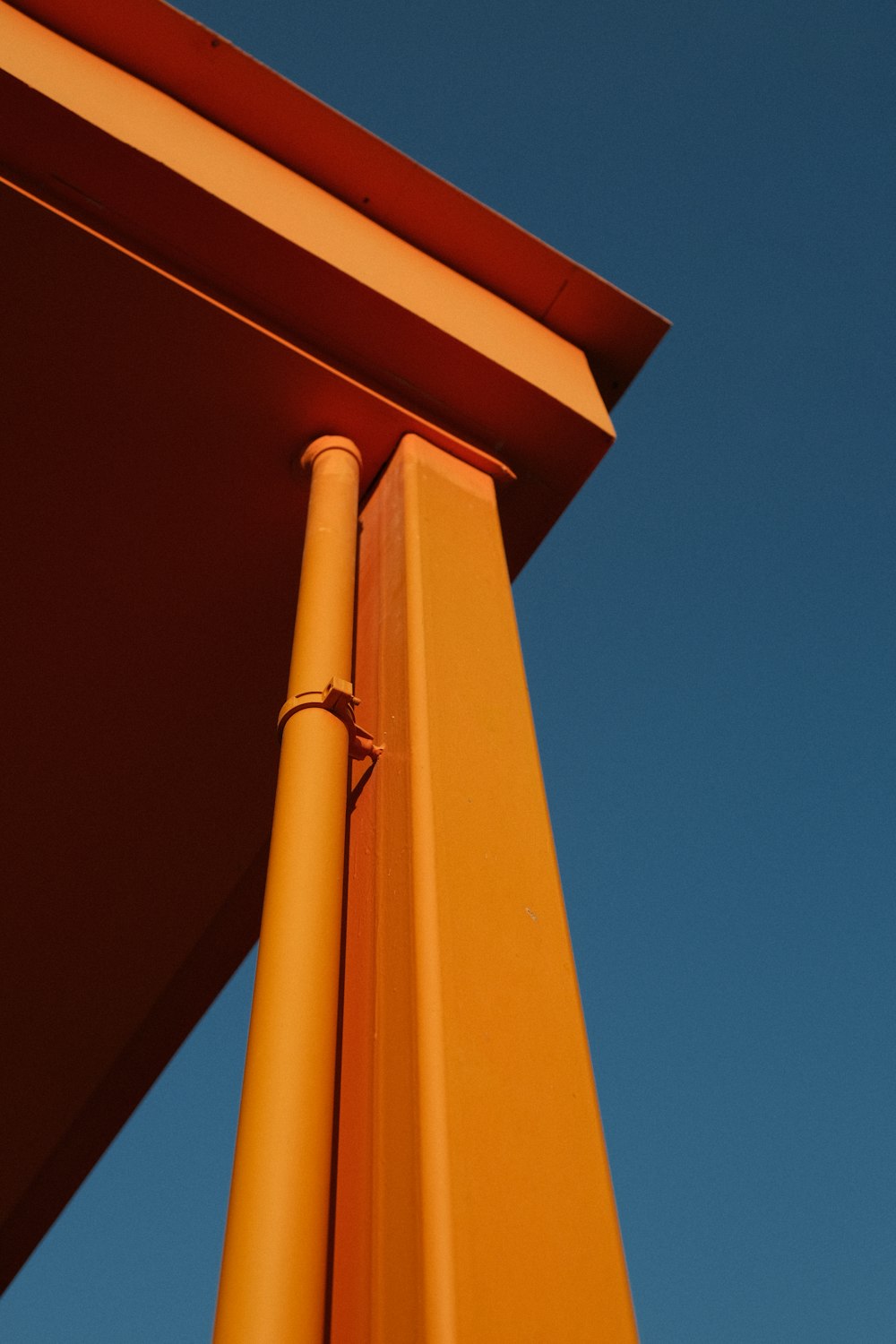 a close up of a yellow pole against a blue sky