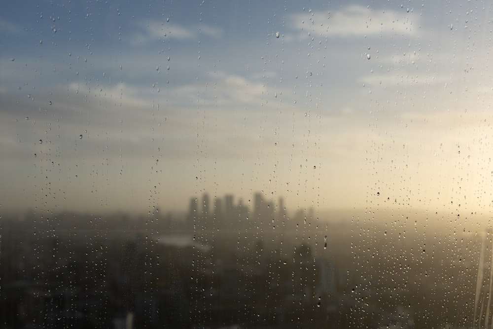 a view of a city through a rain covered window