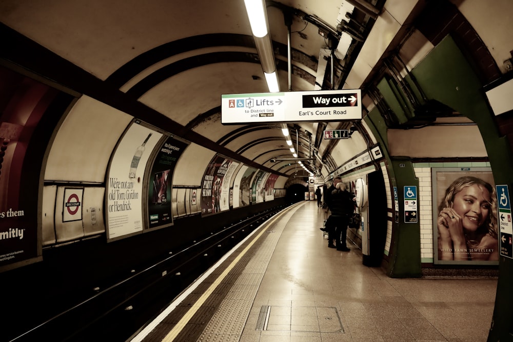 a subway station with people walking on the platform