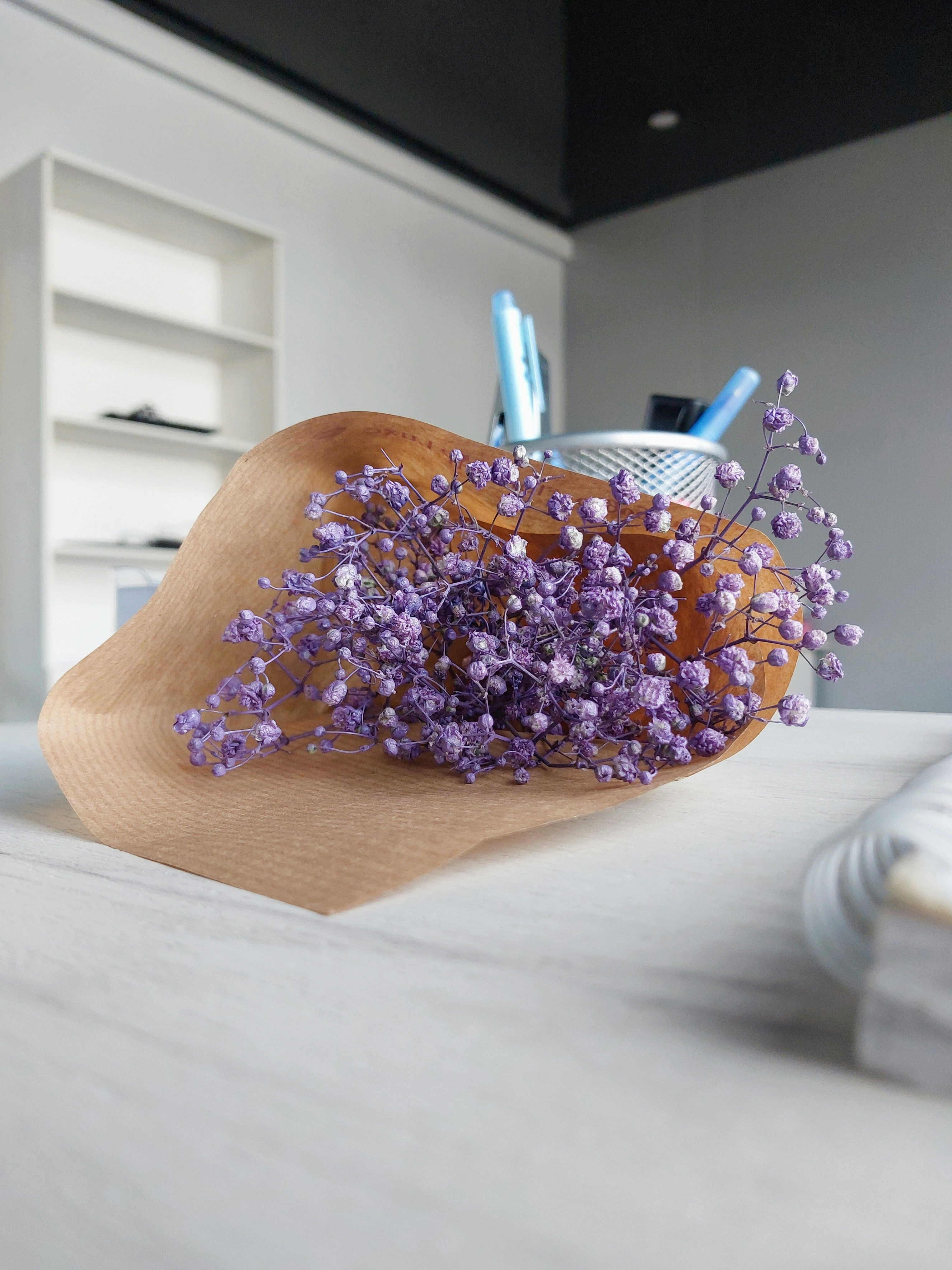 a wooden bowl with a bunch of flowers in it