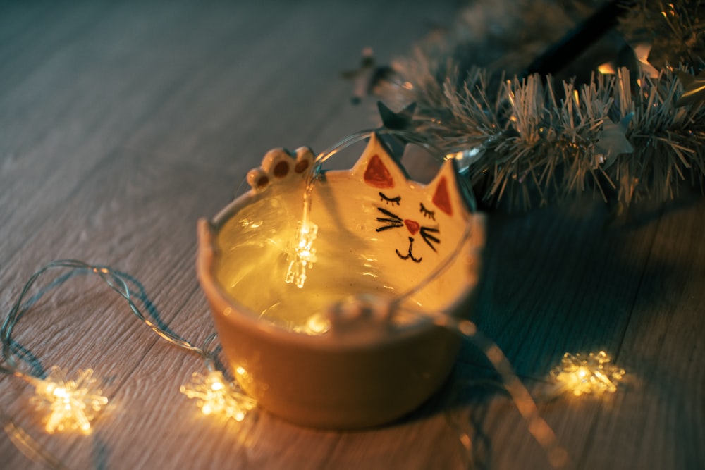 a small bowl with a cat decoration on it