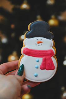 Hand holding a customized cookie cutter with a delicate pop culture design.