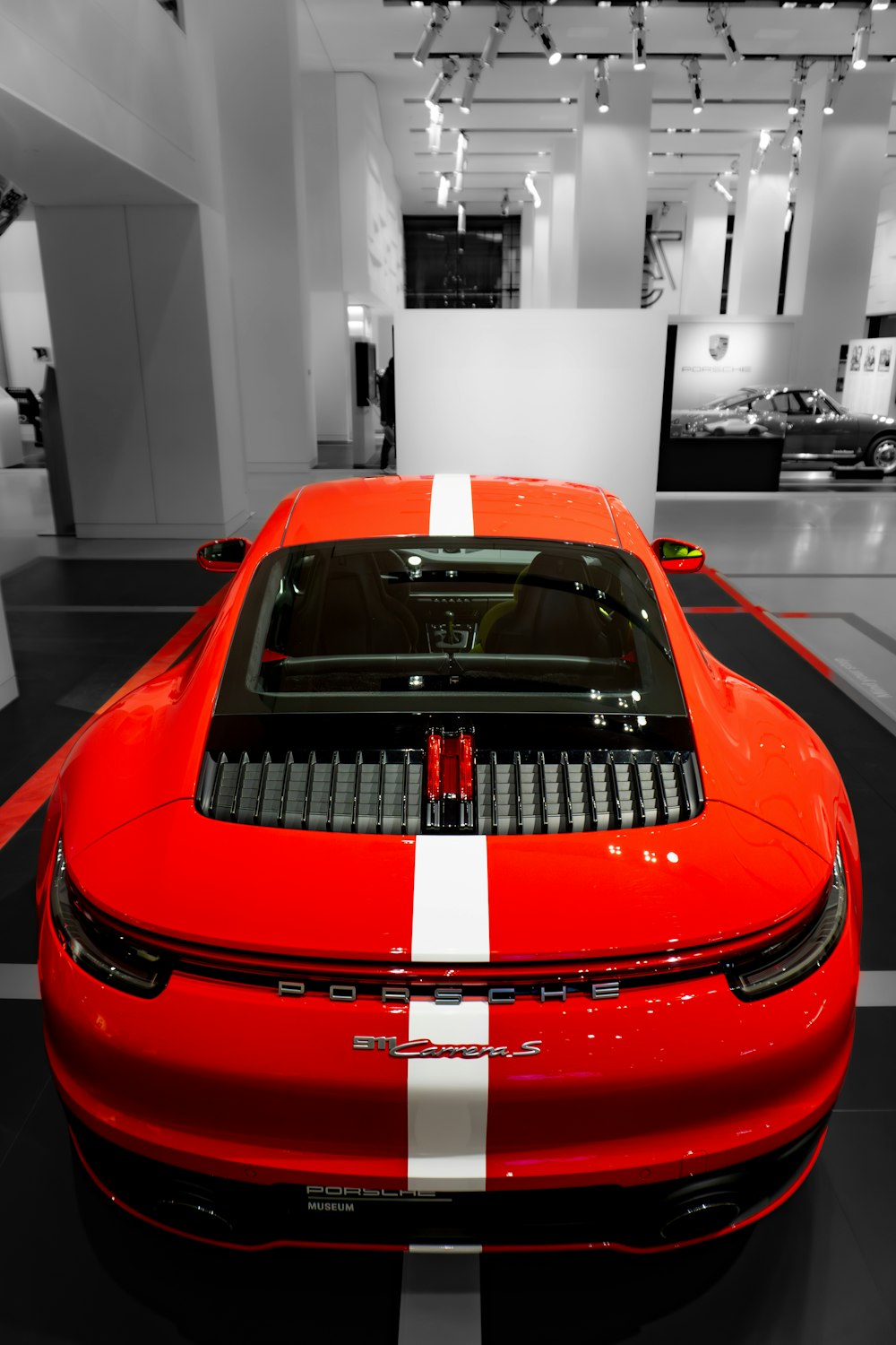 a red sports car parked in a showroom